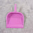 Plastic dustpan with handle, suitable for multiple cleaning tasks.